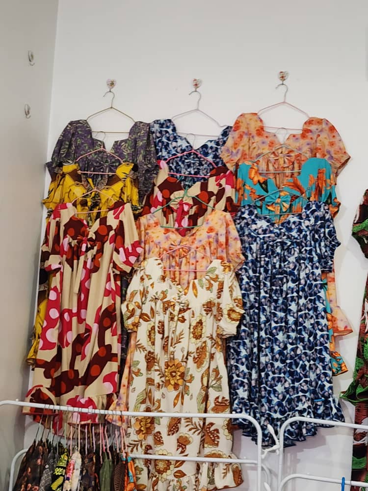 Blue and cream dresses on rail
